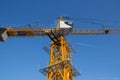 Tower crane against the blue sky. Tower crane operator`s cabin. Crane operator at work Royalty Free Stock Photo