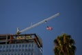 Tower Crane with an American flag near a modern office building under construction Royalty Free Stock Photo