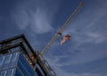 Tower Crane with an American flag near a modern office building under construction Royalty Free Stock Photo