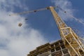 Tower crane on the background of the facade of the building. Lifting mechanism on the construction site Royalty Free Stock Photo