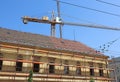 Tower crane behind an old building under restoration Royalty Free Stock Photo