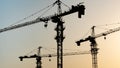 Tower crane at building construction site silhouette Royalty Free Stock Photo