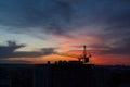 Tower crane and building construction site silhouette at sunrise. Royalty Free Stock Photo