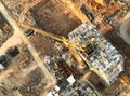 Tower crane on building construction, top view. Builder on formworks