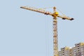 Tower crane building a house. Concrete building under construction. Construction site Royalty Free Stock Photo