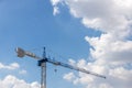 Tower Crane in the clouds and blue sky. The Crane tower in construction site of a high-rise condominium. High cranes on the constr