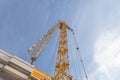 Tower crane at a construction site. Lowered tower crane on sky background Royalty Free Stock Photo
