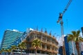 Tower crane on the construction site of a modern building near the sea Royalty Free Stock Photo