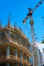 Tower crane on the construction site of a modern building near the sea Royalty Free Stock Photo