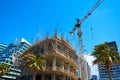 Tower crane on the construction site of a modern building near the sea Royalty Free Stock Photo