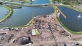 Tower crane at industrial construction site. View from above of new developing residense in american city suburbs