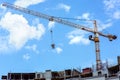 The tower crane lifts the tank with concrete. Royalty Free Stock Photo