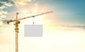 The tower crane lifts the white plate Royalty Free Stock Photo