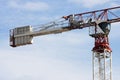 Tower crane machine, operators cab and load weights. Sky behind