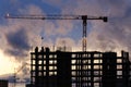 Tower crane, workers work at construction site. Process of building new houses Royalty Free Stock Photo