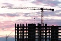 Tower crane, workers work at construction site. Process of building new houses Royalty Free Stock Photo