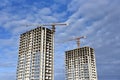 Tower cranes build the high-rise building. Crane working at construction site. New residential skyscraper on blue sky background Royalty Free Stock Photo