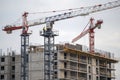 Tower cranes in close-up on a building construction site Royalty Free Stock Photo