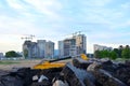 Tower cranes constructing a new building at a construction site on the sunset and blue sky background. Royalty Free Stock Photo