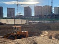 Tower cranes constructing a new residential building. Construction work site and high rise building against blue sky. Construction Royalty Free Stock Photo