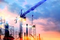 Tower cranes at construction site with sun Royalty Free Stock Photo
