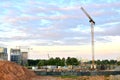 Tower cranes and new residential buildings at a huge construction site on the sunset and blue sky background Royalty Free Stock Photo