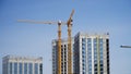 Tower cranes next to modern high-rise buildings under construction Royalty Free Stock Photo