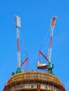 Tower cranes on top of building under constraction Royalty Free Stock Photo