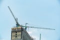 Tower cranes on the top of construction site Royalty Free Stock Photo