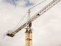 Tower cranes work during the construction of a multi-story building. New apartments for residents and premises for offices. Risky Royalty Free Stock Photo