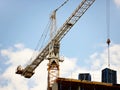 Tower cranes work during the construction of a multi-story building. New apartments for residents and premises for offices. Risky Royalty Free Stock Photo