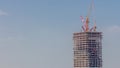 Tower cranes working on the construction site of new skyscraper high-rise building aerial timelapse. Dubai Royalty Free Stock Photo