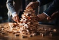 A Tower of Creativity: People Building, Collaborating, and Inspiring with Wooden Blocks Royalty Free Stock Photo