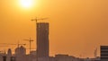 A tower in Doha timelapse, Qatar, under construction, silhouetted against the sunset. Royalty Free Stock Photo