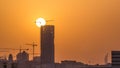 A tower in Doha timelapse, Qatar, under construction, silhouetted against the sunset. Royalty Free Stock Photo