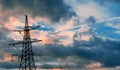 Tower electrical lines are silhouette on beautiful sunset.