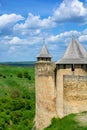 the tower of the fortress of Khotyn on a spring day against the background of green fields Royalty Free Stock Photo