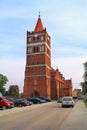 Tower of Friedland's Lutheran church with a clock in Gothic style