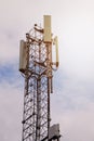 Tower with 5G and 4G cellular network antenna on blue cloudy sky background Royalty Free Stock Photo