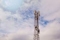 Tower with 5G and 4G cellular network antenna on blue cloudy sky background Royalty Free Stock Photo