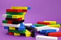 Tower game and scattered colored wooden blocks Royalty Free Stock Photo