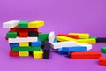 Tower game and scattered colored wooden blocks Royalty Free Stock Photo