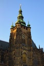 Tower with golden clock against blue sky. Saint Vitus Cathedral, Wenceslas and Adalbert Cathedral in Hradcany Royalty Free Stock Photo