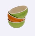 A tower of green and orange ceramic plates, natural bright color