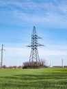 Tower of a high voltage electric transmission line against a blue sky Royalty Free Stock Photo