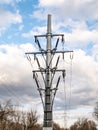 The tower of a high-voltage electricity line against a cloudy sky Royalty Free Stock Photo