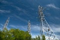 Tower with high-voltage energy transmission wires against the blue sky. High-voltage tower. Electrical wires and fuses Royalty Free Stock Photo