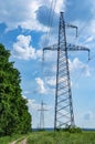 Tower with high-voltage energy transmission wires against the blue sky. Royalty Free Stock Photo