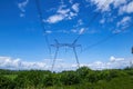 Tower with high-voltage energy transmission wires against the blue sky. Royalty Free Stock Photo