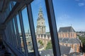 Tower of the historic Martini church through the windows of the Forum in Groningen